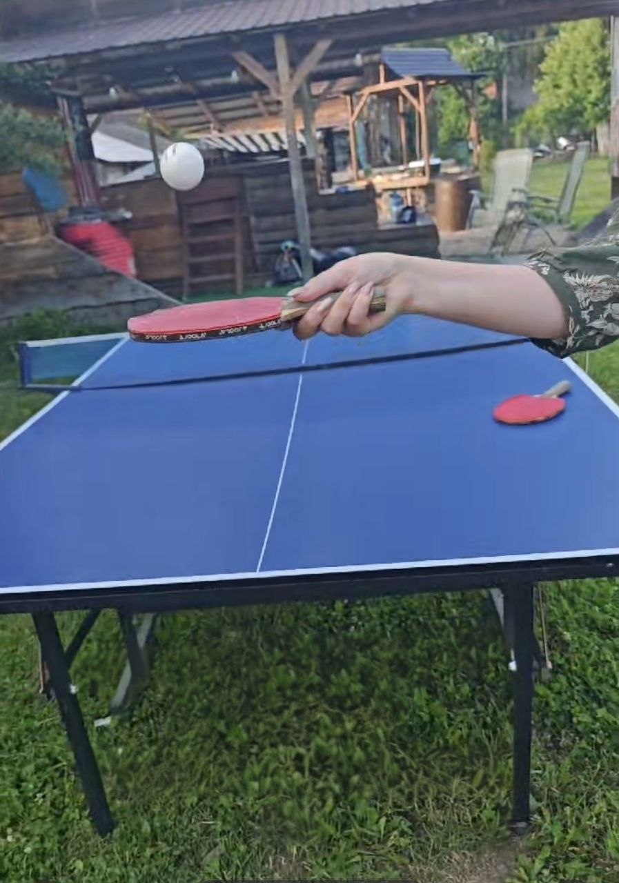Outdoor table tennis game at Two Boots Ranch